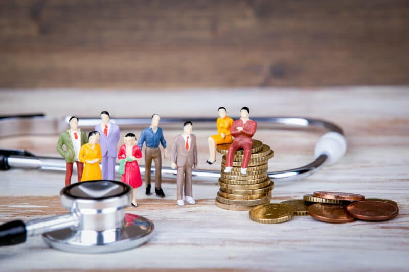 Medical care and expenses, health insurance. Colorful Human miniatures.